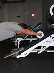 Standing, inclined, using Ab Wheel. Photo via Jim Bathurst.