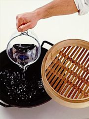 Filling wok with water